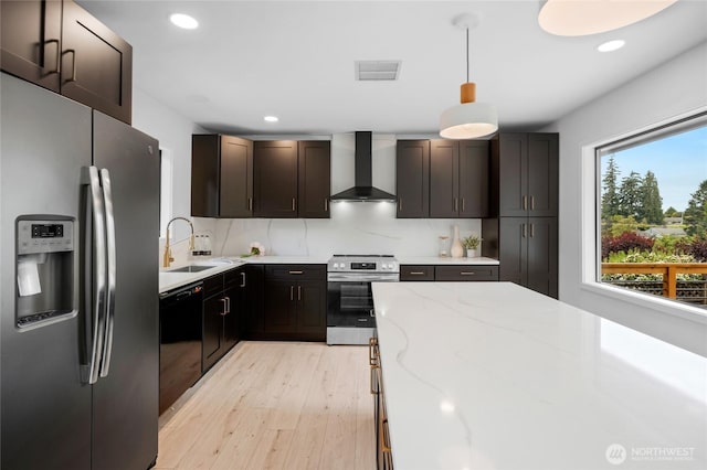 406 Center Pl, Everett, WA 98203 - kitchen featuring stainless steel appliances, wall chimney exhaust hood, a sink, light wood-style floors, and light stone countertops