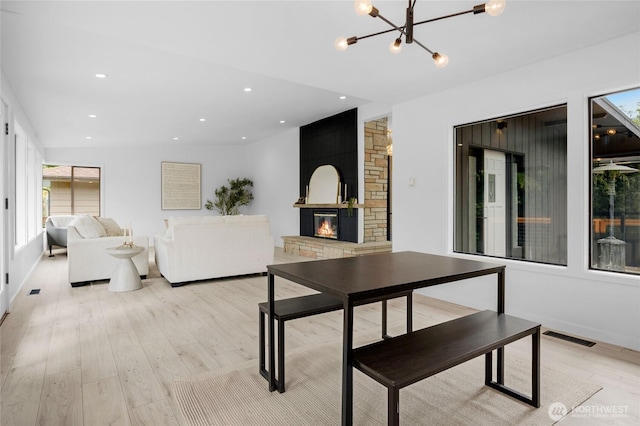 406 Center Pl, Everett, WA 98203 - living room with a chandelier, light wood-type flooring, a stone fireplace, and recessed lighting