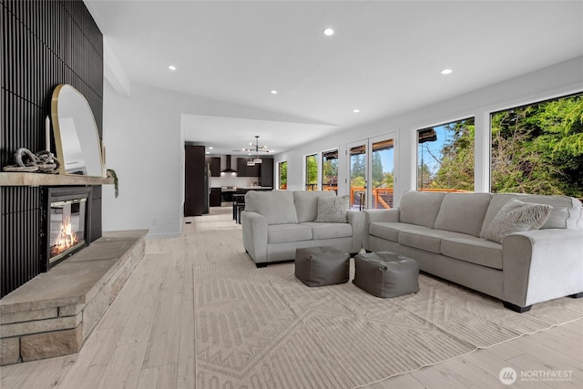 406 Center Pl, Everett, WA 98203 - living room with light wood-style flooring, recessed lighting, a glass covered fireplace, lofted ceiling, and a chandelier