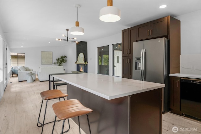 406 Center Pl, Everett, WA 98203 - kitchen with dishwasher, dark brown cabinets, a center island, light countertops, and open floor plan