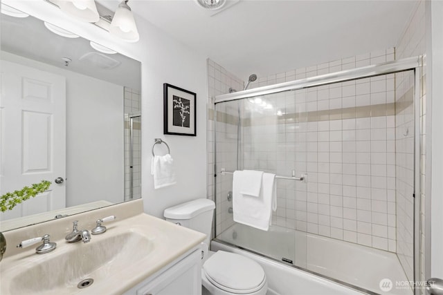 3717 California Ave SW Unit 304, Seattle, WA 98116 - bathroom featuring toilet, vanity, and shower / bath combination with glass door