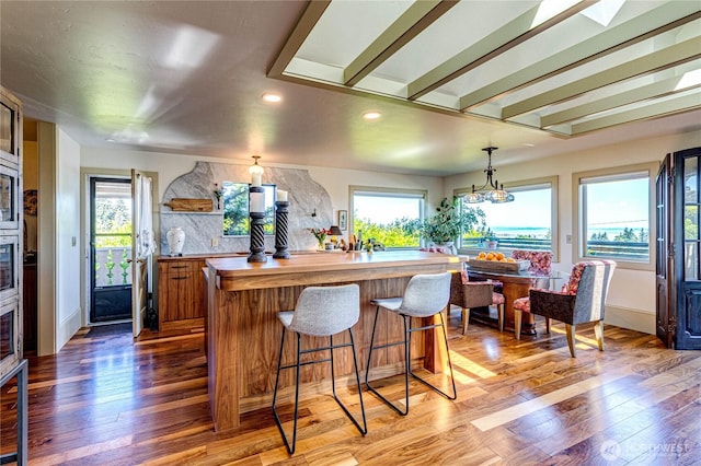 1716 E 4th St, Port Angeles, WA 98362 - kitchen with wooden counters, light wood-type flooring, recessed lighting, a kitchen breakfast bar, and a kitchen island