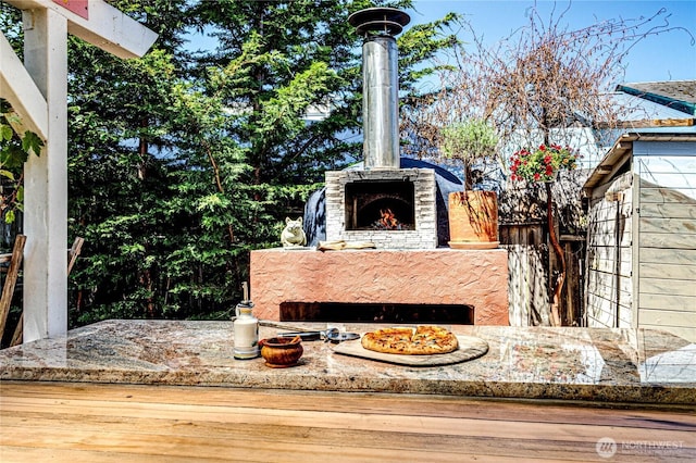 1716 E 4th St, Port Angeles, WA 98362 - exterior view of an outdoor stone fireplace and a wood stove