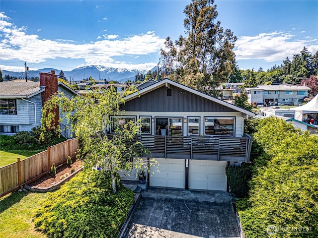 1716 E 4th St, Port Angeles, WA 98362 - view of front of home featuring a garage, a mountain view, a balcony, and driveway