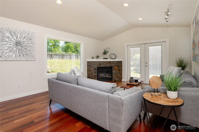1416 Wilson Ave, Blaine, WA 98230 - living room featuring vaulted ceiling, dark wood finished floors, baseboards, french doors, and a fireplace