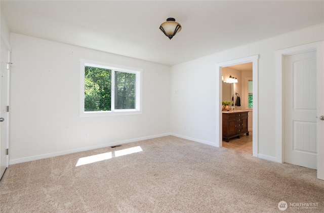 1416 Wilson Ave, Blaine, WA 98230 - unfurnished bedroom with light colored carpet, baseboards, and connected bathroom