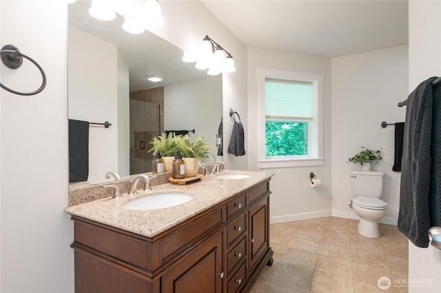 1416 Wilson Ave, Blaine, WA 98230 - bathroom with double vanity, a tile shower, toilet, baseboards, and tile patterned floors