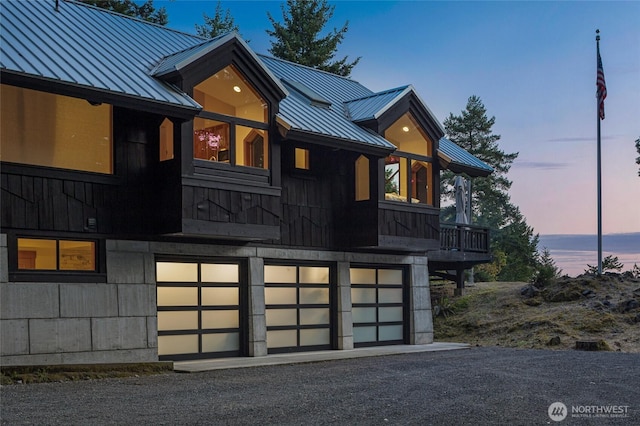 815 Carefree Way, Friday Harbor, WA 98250 - view of front facade featuring a standing seam roof, a garage, a metal roof, and driveway