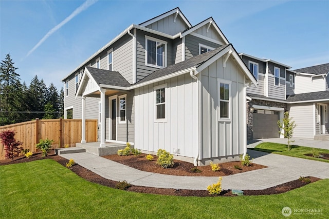 20620 97th Avenue St E Unit 16, Graham, WA 98338 - view of front of house featuring board and batten siding, a garage, driveway, and a shingled roof