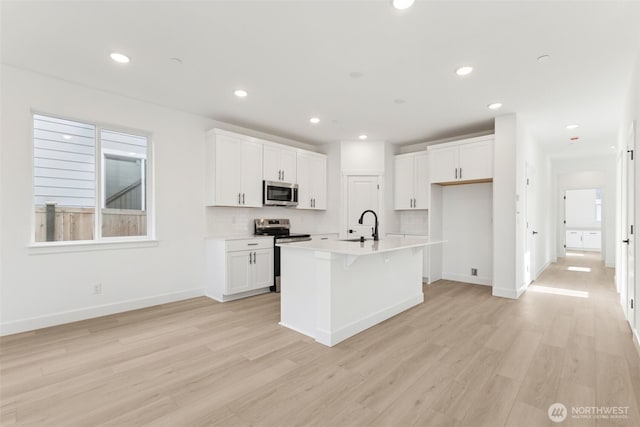 20620 97th Avenue St E Unit 16, Graham, WA 98338 - kitchen featuring stainless steel appliances, a sink, light wood-style floors, white cabinetry, and recessed lighting