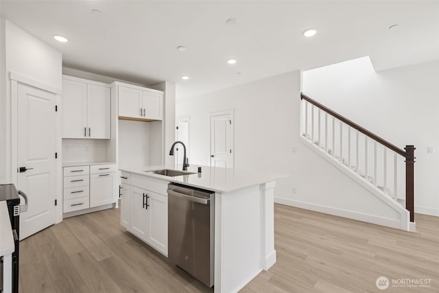 20620 97th Avenue St E Unit 16, Graham, WA 98338 - kitchen with stainless steel dishwasher, a sink, light wood-style floors, white cabinets, and recessed lighting