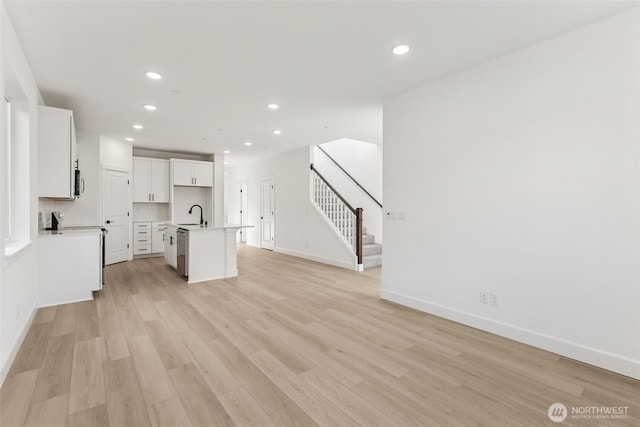 20620 97th Avenue St E Unit 16, Graham, WA 98338 - unfurnished living room with a sink, recessed lighting, stairway, baseboards, and light wood-type flooring