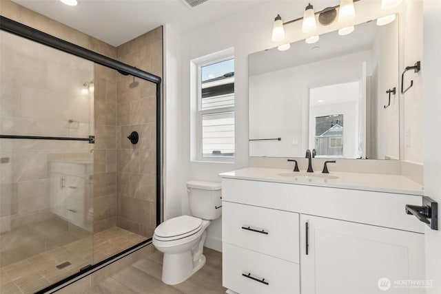 20620 97th Avenue St E Unit 16, Graham, WA 98338 - full bathroom featuring toilet, vanity, a shower stall, plenty of natural light, and recessed lighting