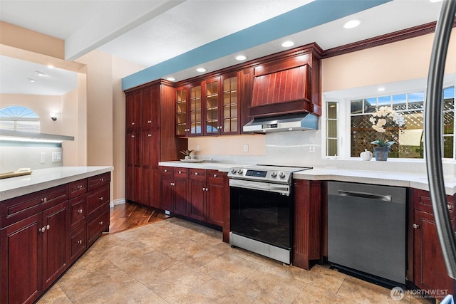 1550 N Narrows Dr, Tacoma, WA 98406 - kitchen featuring appliances with stainless steel finishes, reddish brown cabinets, wall chimney exhaust hood, light countertops, and recessed lighting