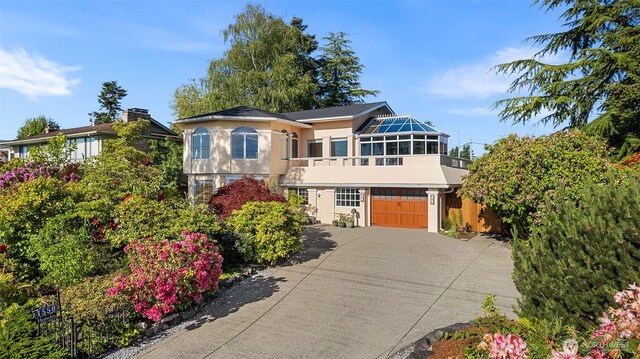 1550 N Narrows Dr, Tacoma, WA 98406 - view of front of property with concrete driveway, stucco siding, a garage, and a balcony