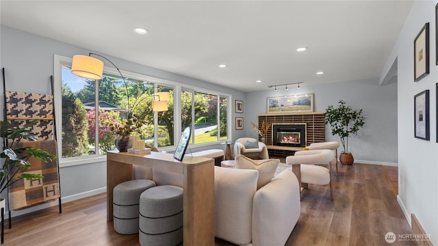 9824 NE 139th St, Kirkland, WA 98034 - living room featuring baseboards, wood finished floors, recessed lighting, and a glass covered fireplace