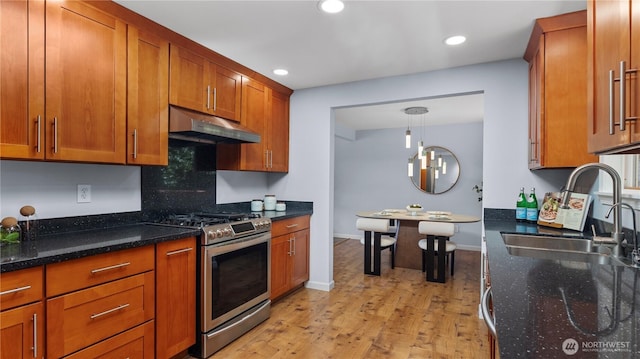 9824 NE 139th St, Kirkland, WA 98034 - kitchen with stainless steel gas range, under cabinet range hood, a sink, light wood-type flooring, and brown cabinets