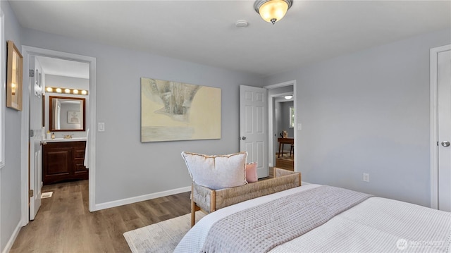 9824 NE 139th St, Kirkland, WA 98034 - bedroom with wood finished floors, baseboards, a sink, and ensuite bath