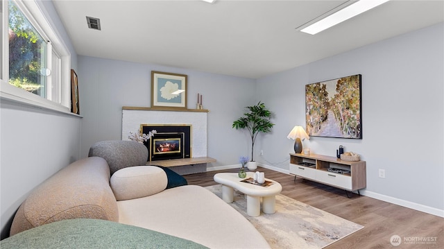 9824 NE 139th St, Kirkland, WA 98034 - living area featuring wood finished floors, a brick fireplace, and baseboards