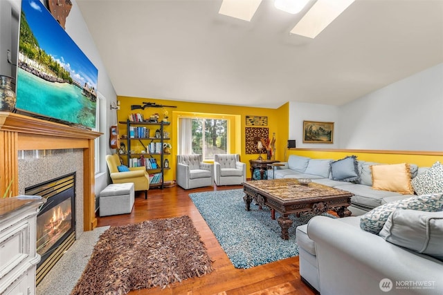 6940 35th St W, University Place, WA 98466 - living room with a glass covered fireplace, wood finished floors, and a skylight
