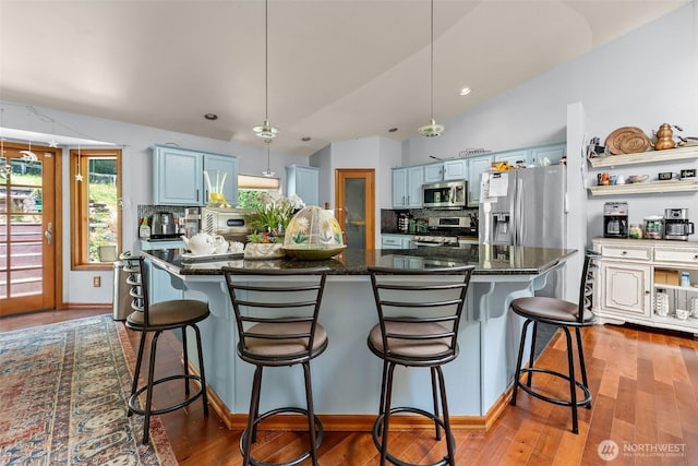 6940 35th St W, University Place, WA 98466 - kitchen with stainless steel appliances, blue cabinets, decorative backsplash, wood finished floors, and recessed lighting
