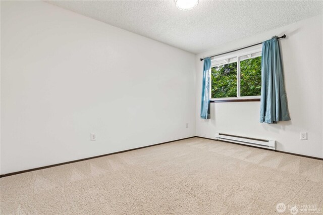 5116 54th St W, University Place, WA 98467 - carpeted spare room featuring a baseboard radiator, a textured ceiling, and baseboards