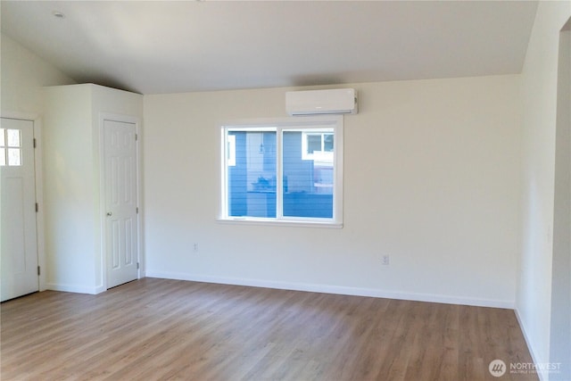 1645 S 272nd St Unit 11, Federal Way, WA 98003 - unfurnished room with a wall mounted AC, light wood-type flooring, and baseboards