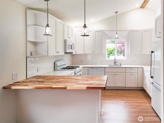 1645 S 272nd St Unit 11, Federal Way, WA 98003 - kitchen featuring white appliances, a peninsula, a sink, wooden counters, and light wood-type flooring