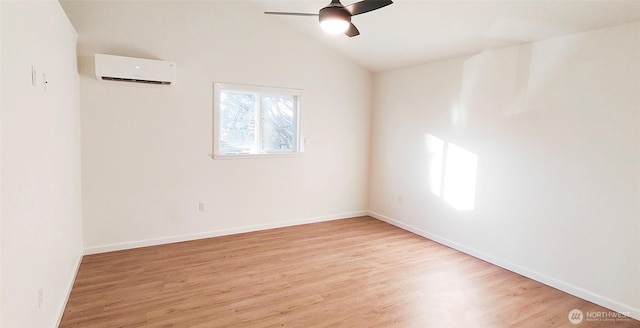 1645 S 272nd St Unit 11, Federal Way, WA 98003 - empty room with a ceiling fan, wood finished floors, vaulted ceiling, a wall unit AC, and baseboards