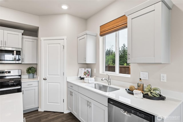 7318 281st Pl NW Unit 42, Stanwood, WA 98292 - kitchen with stainless steel appliances, a sink, dark wood-style flooring, light countertops, and recessed lighting