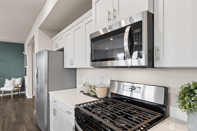 7318 281st Pl NW Unit 42, Stanwood, WA 98292 - kitchen featuring appliances with stainless steel finishes, white cabinetry, light countertops, and dark wood-type flooring