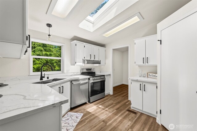 12323 Burchard Dr SW, Port Orchard, WA 98367 - kitchen with appliances with stainless steel finishes, a sink, under cabinet range hood, and white cabinets