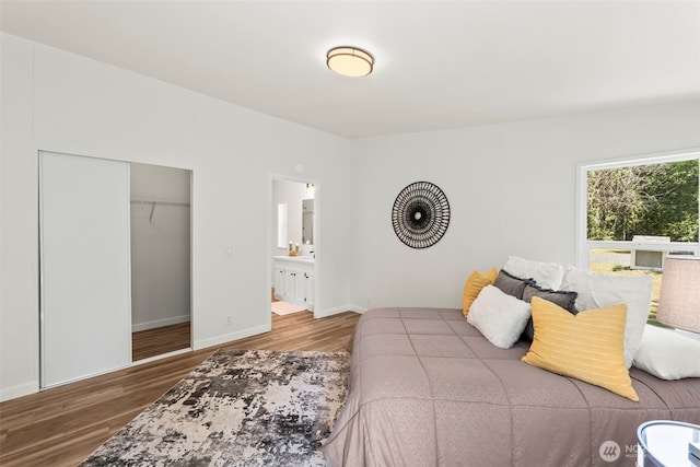 12323 Burchard Dr SW, Port Orchard, WA 98367 - bedroom featuring wood finished floors, ensuite bathroom, a closet, and baseboards