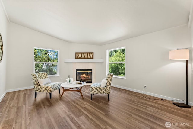 12323 Burchard Dr SW, Port Orchard, WA 98367 - living area featuring a tile fireplace, baseboards, plenty of natural light, and vaulted ceiling