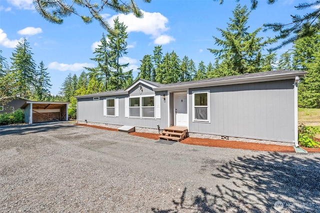 12323 Burchard Dr SW, Port Orchard, WA 98367 - manufactured / mobile home featuring crawl space, gravel driveway, and a carport