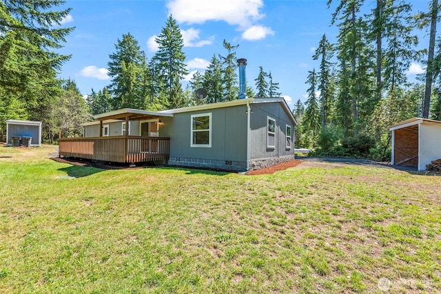 12323 Burchard Dr SW, Port Orchard, WA 98367 - back of property with crawl space, a wooden deck, and a lawn