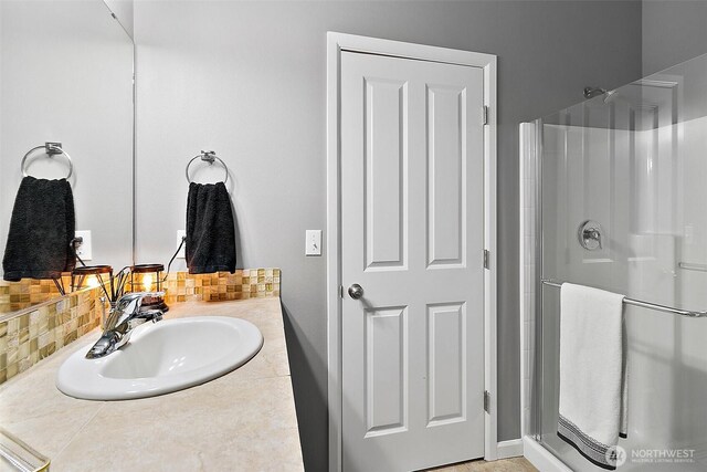 10508 174th Ave E, Bonney Lake, WA 98391 - bathroom with a shower stall, vanity, and decorative backsplash