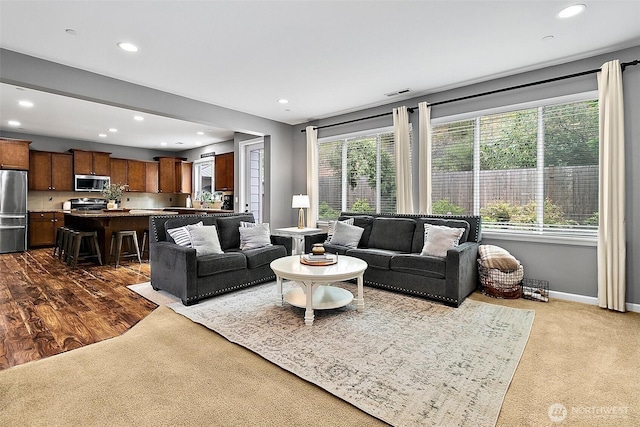 10508 174th Ave E, Bonney Lake, WA 98391 - living room featuring plenty of natural light, recessed lighting, dark carpet, and baseboards