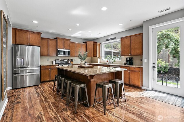 10508 174th Ave E, Bonney Lake, WA 98391 - kitchen with stainless steel appliances, dark wood-type flooring, brown cabinets, recessed lighting, and a kitchen island