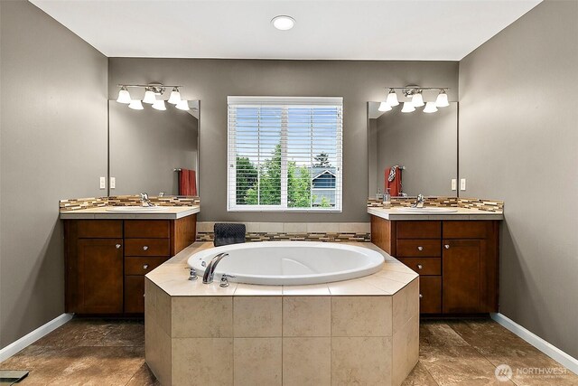 10508 174th Ave E, Bonney Lake, WA 98391 - bathroom featuring two vanities, a bath, baseboards, and recessed lighting