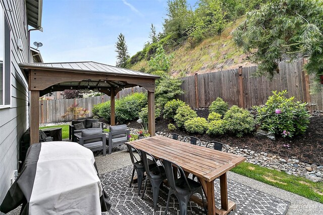 10508 174th Ave E, Bonney Lake, WA 98391 - fenced backyard with a gazebo, an outdoor hangout area, a patio area, and outdoor dining space