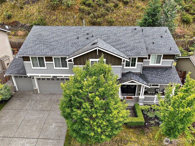 10508 174th Ave E, Bonney Lake, WA 98391 - view of front of house featuring board and batten siding, concrete driveway, and stone siding