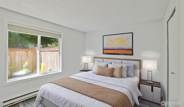 14600 SE 176th St Unit V1, Renton, WA 98058 - bedroom with a baseboard heating unit and wood finished floors
