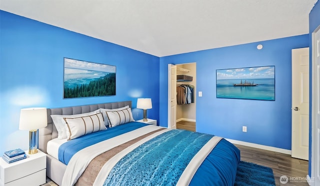 14600 SE 176th St Unit V1, Renton, WA 98058 - bedroom featuring wood finished floors, baseboards, and a walk in closet
