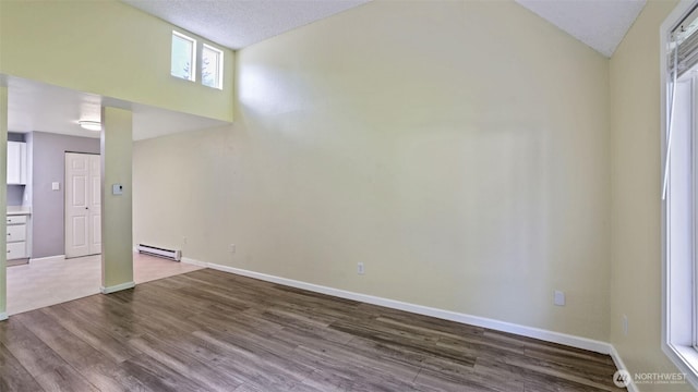 14600 SE 176th St Unit V1, Renton, WA 98058 - unfurnished living room with a baseboard radiator, lofted ceiling, dark wood-style floors, and baseboards