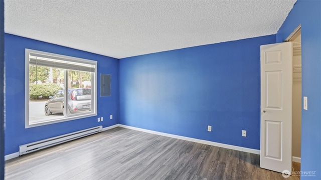14600 SE 176th St Unit V1, Renton, WA 98058 - empty room with a baseboard radiator, wood finished floors, a textured ceiling, baseboards, and electric panel
