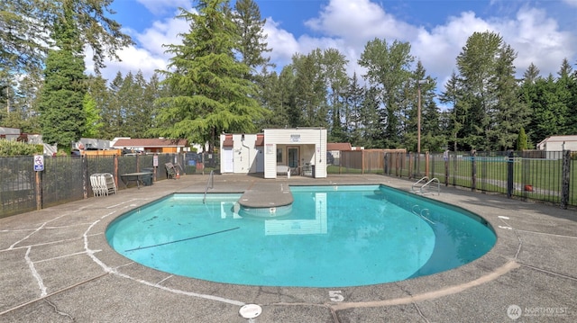14600 SE 176th St Unit V1, Renton, WA 98058 - community pool featuring an outdoor structure, a patio area, and view of wooded area