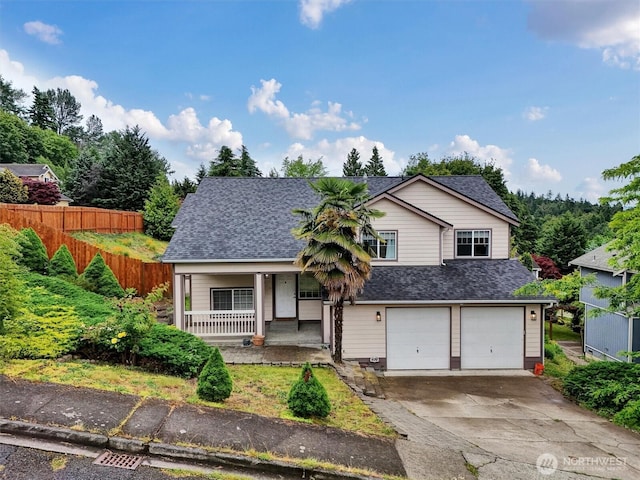 9505 S 214th Pl, Kent, WA 98031 - view of front of home with covered porch, a shingled roof, an attached garage, and concrete driveway