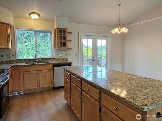 9002 Shadberry Dr SE, Olympia, WA 98513 - kitchen with dishwashing machine, a sink, french doors, wood finished floors, and brown cabinetry