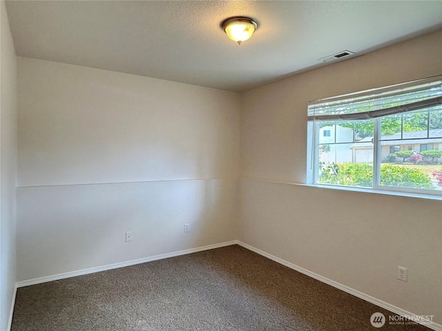 9002 Shadberry Dr SE, Olympia, WA 98513 - spare room featuring dark colored carpet and baseboards